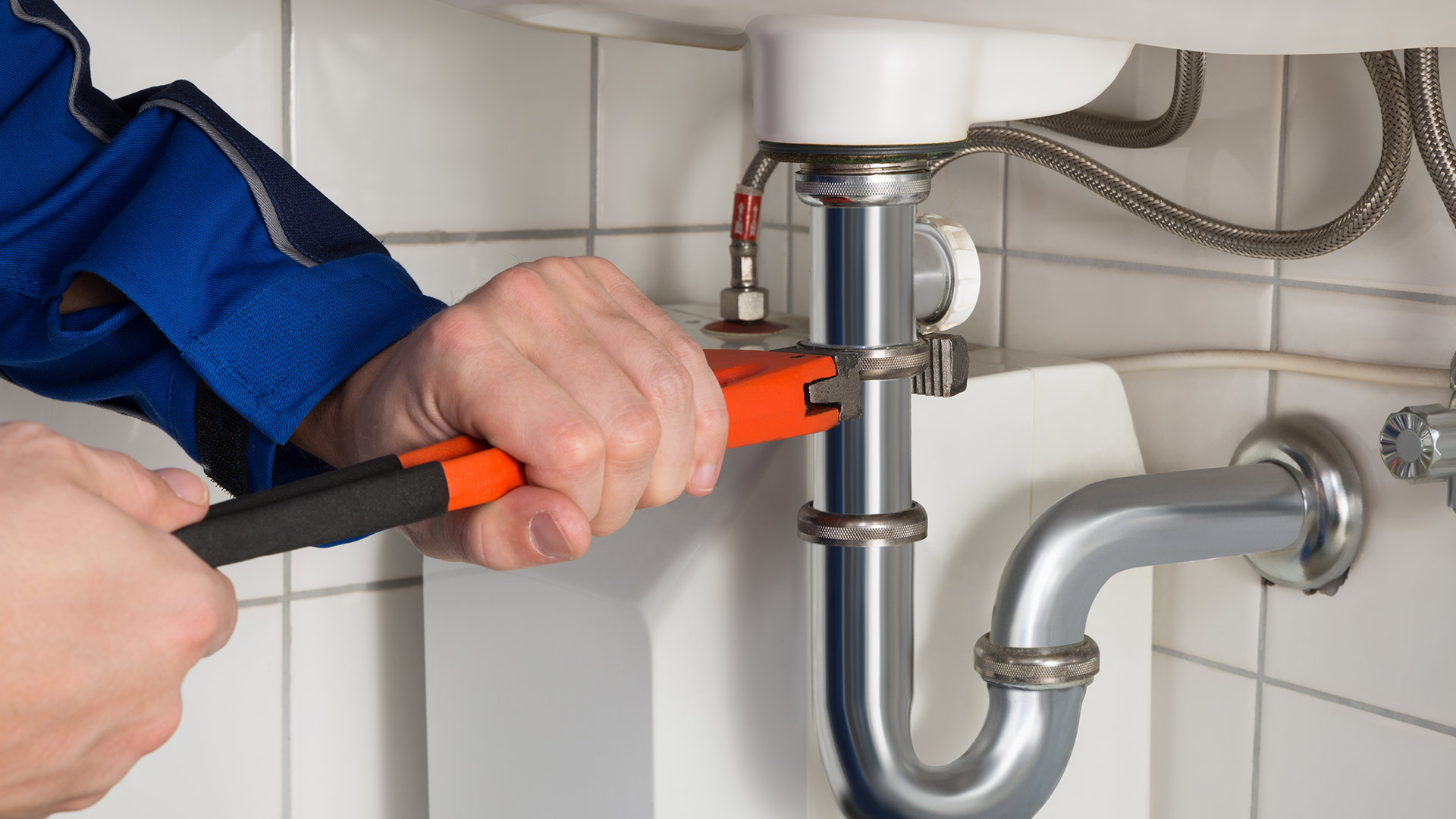 plumber hand close up with wrench repairing bathroom pipe warren oh